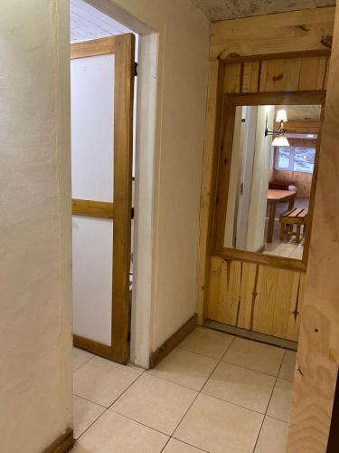 an empty room with a door and a table at Lodge Copahue Expeditions in Caviahue