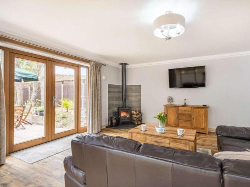 a living room with a couch and a fireplace at 2 bed in Dereham 86115 in Bawdeswell