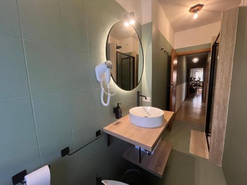 a bathroom with a sink and a mirror at CASA DORA sunflower apartment in Fucecchio