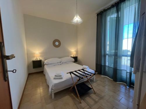 a small bedroom with a bed and a window at CASA DORA sunflower apartment in Fucecchio