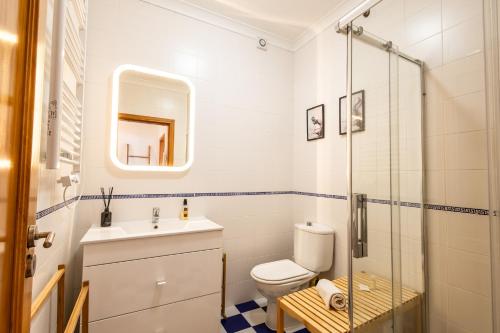 a bathroom with a toilet and a sink and a shower at Carmonas 32 Hill in São Martinho do Porto