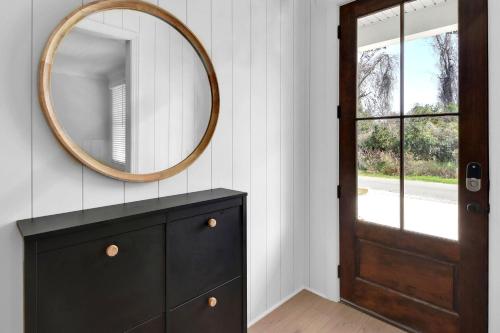 a bathroom with a black dresser and a mirror at 21 Orchard Road in Island Retreat