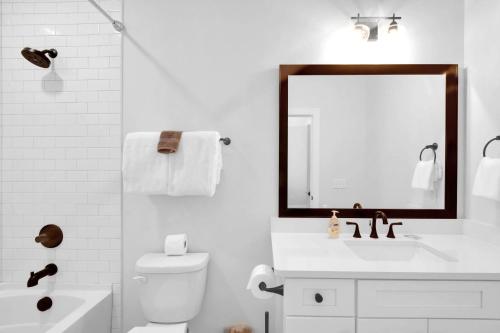 a white bathroom with a sink and a mirror at 21 Orchard Road in Island Retreat
