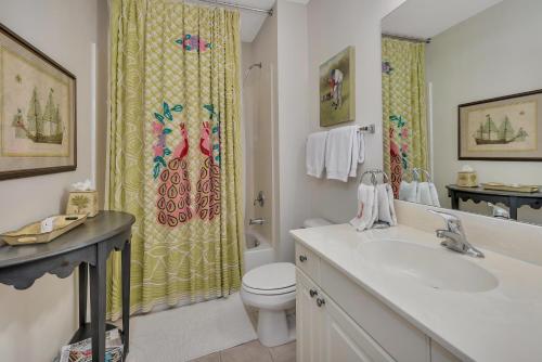 a bathroom with a sink and a toilet and a shower at Windward Point 210 in Harrington
