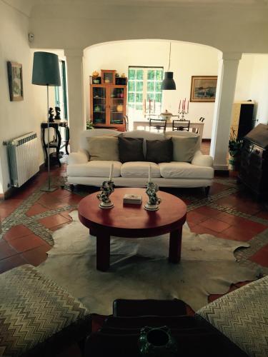 a living room with a couch and a coffee table at Ha Mar ao Luar in Setúbal