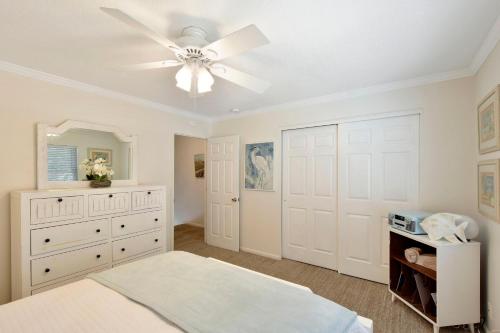 a bedroom with a bed and a ceiling fan at Kingstowne 425 #B in Golf Retreat