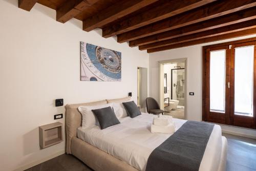 a bedroom with a large white bed and a window at GuestHost - Santo 86 Luxury Rooms in Padova