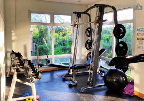 a gym with a bunch of treadmills and weights at Palawan Luxury 2BR Condo with Pool, Gym & Parking - B1 5Kunzite in Puerto Princesa City