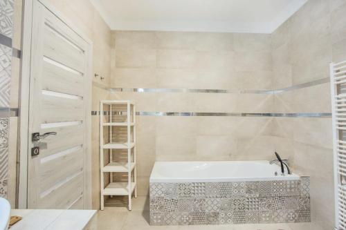 a bathroom with a white tub and a ladder at Dom Tomášov D in Senec