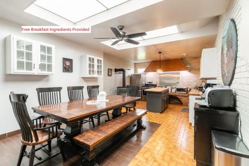 a kitchen and dining room with a wooden table and chairs at Beautiful home, a few minutes to the waterfall and attractions in Niagara Falls