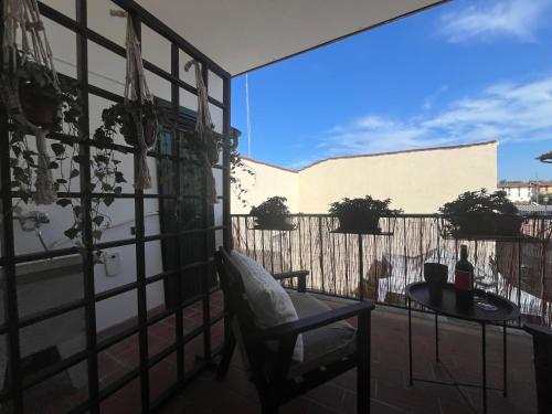 a balcony with a chair and a table with a view at CASA DORA sunflower apartment in Fucecchio