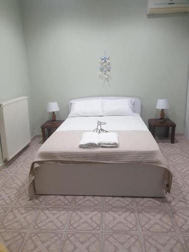 a bed in a room with two nightstands and two tables at Katerina's Home in Ancient Epidavros