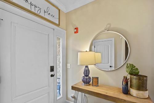 a hallway with a mirror and a table with a lamp at Coastal Escape in Jewtown