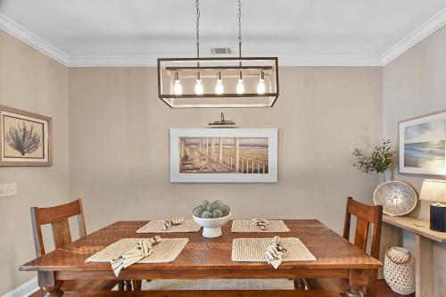 a dining room with a wooden table with chairs at Coastal Escape in Jewtown