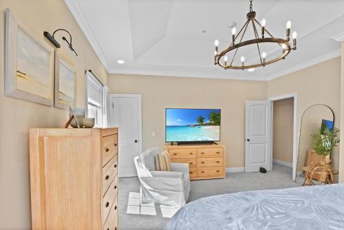 a bedroom with a bed and a dresser and a tv at Coastal Escape in Jewtown