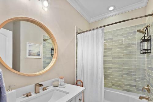a bathroom with a sink and a mirror and a shower at Coastal Escape in Jewtown