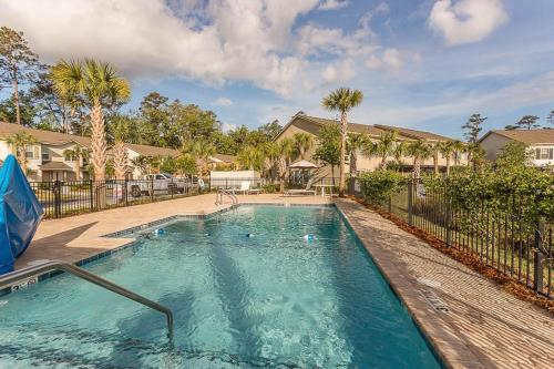 a swimming pool in a yard with a fence at Coastal Escape in Jewtown