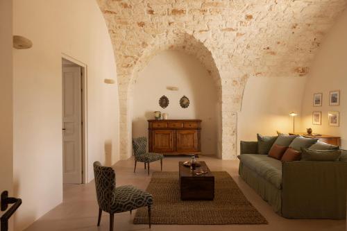 a living room with a couch and a table at Masseria Tarsia Morisco in Polignano a Mare