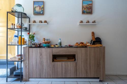 a kitchen with a wooden island in a room at A 2 pas d AZAY in Neuil