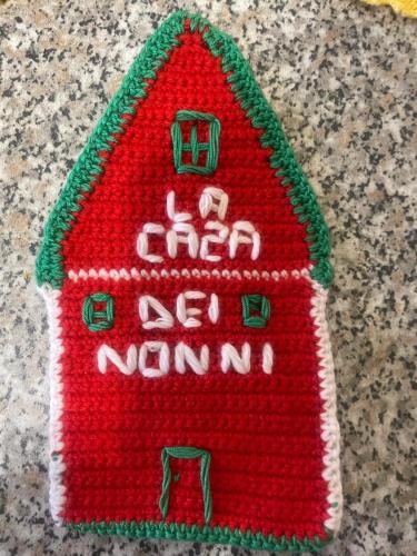 a red knitted gingerbread house on a table at La Casa dei Nonni in Bracciano
