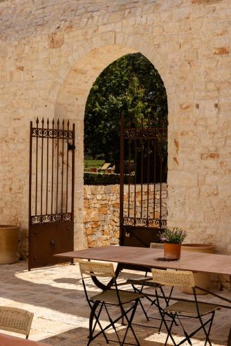 a wooden table and chairs in front of a gate at Masseria Tarsia Morisco in Polignano a Mare