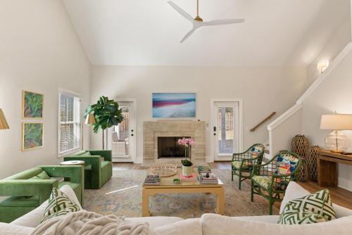 a living room with green furniture and a fireplace at 23 Orchard Rd in Island Retreat