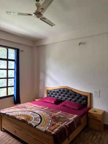 a bedroom with a large bed with a ceiling at Pine view kasol in Kasol