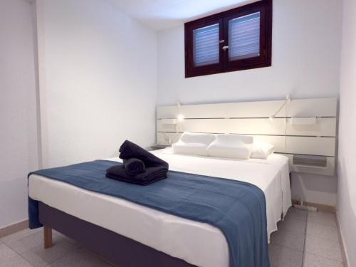 a bedroom with a bed with a towel on it at Acapulco Beach in Costa de Adeje