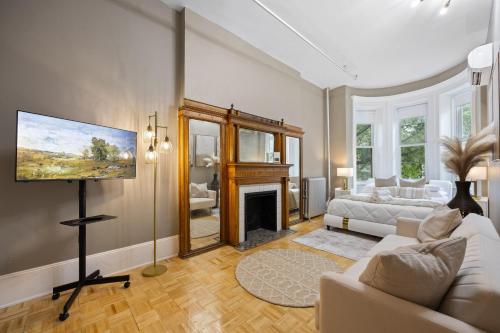 a living room with a couch and a fireplace at Vintage Luxe NY - Designer Lofts & Apartments NYC in New York