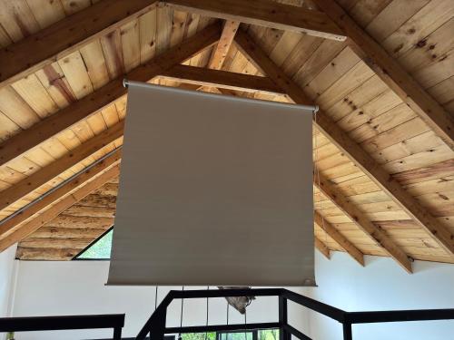 a large projection screen in a wooden ceiling at Cabaña Malbec - La Cava Lodge in Medellín