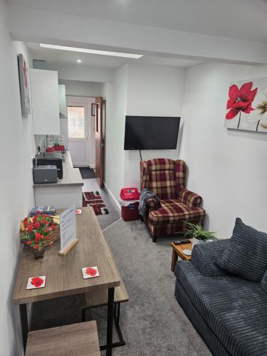 a living room with a couch and a table at Cosy Corner - Town centre flat with free nearby parking in Shrewsbury