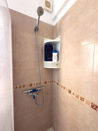 a shower with a shower head in a bathroom at Acapulco Beach in Costa de Adeje