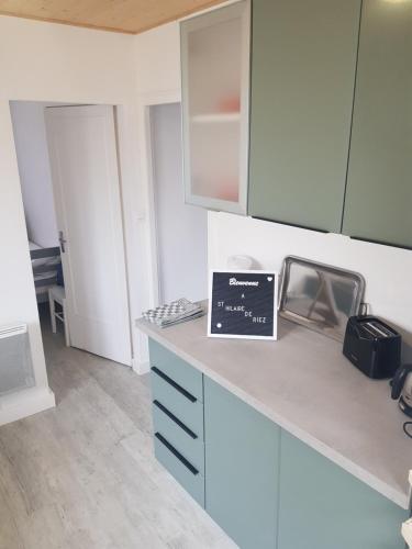 a kitchen with a counter with a laptop on it at la brise marine in Saint-Hilaire-de-Riez