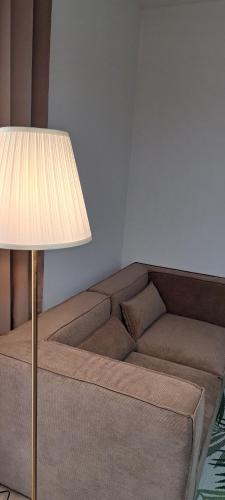 a living room with a couch and a lamp at Fantasticasa in Nettuno