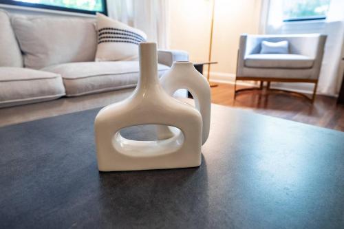 a white vase sitting on a table in a living room at Modern Stay on Green Valley - 2.5 Mi to Downtown in Sunset Hills