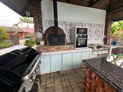 a kitchen with a stove and a stove top oven at Sinurambi Cottage Rental in Penampang