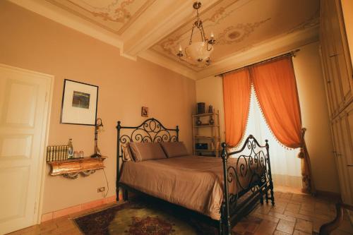 a bedroom with a black bed in a room at Villa Messori Spa in Castelvetro di Modena