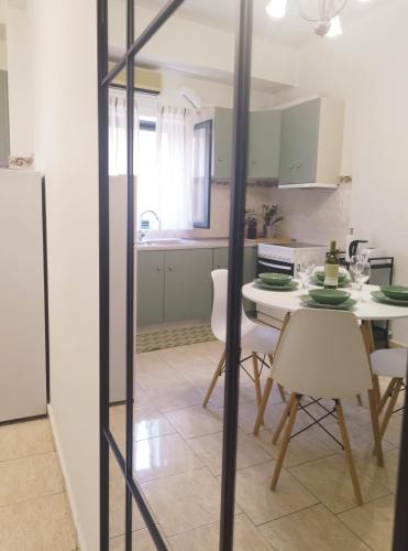 a kitchen and dining room with a table and chairs at Selo Apartments Mani in Agios Nikolaos
