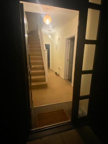 a view of a hallway with stairs in a house at Langham Lake House in Simpson