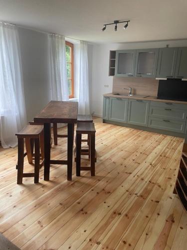a kitchen with a table and chairs in a room at Inselperle - Kämmererhof in Fehmarn