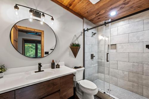 a bathroom with a shower and a toilet and a sink at Luxe 634 By Avada Properties in Pigeon Forge