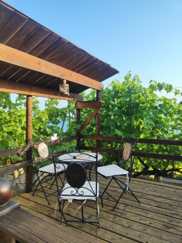 two chairs and a table on a wooden deck at Apartments Mihael in Celina
