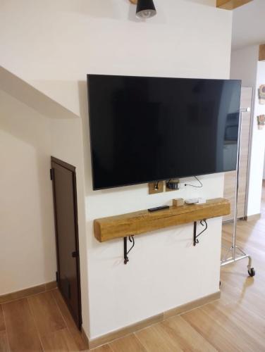 a flat screen tv on a wall in a living room at Casa vacanza SOLE E LUNA in Quartu Sant'Elena