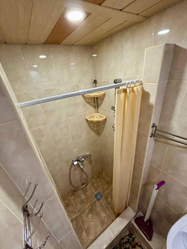 a bathroom with a shower with a shower curtain at Villa Costa in Sanzhiyka