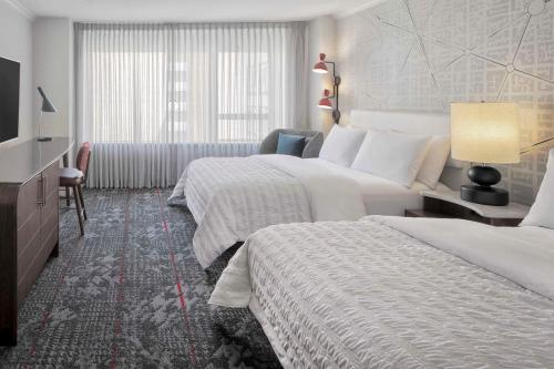 a hotel room with two beds and a television at Le Meridien Washington, DC, The Madison in Washington