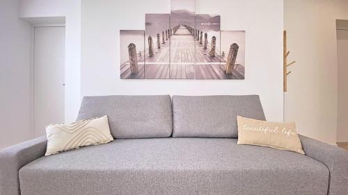a couch in a living room with a painting on the wall at Havre de paix au cœur de la ville in Ay