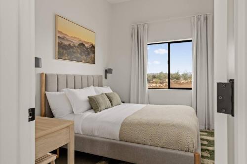 a bedroom with a large bed and a window at Nexus By The Cohost Company in Pioneertown