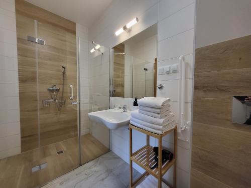 a white bathroom with a sink and a shower at To Tutaj in Szklarska Poręba