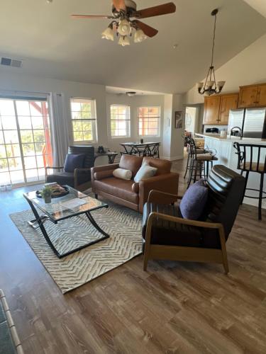 a living room with a couch and a table at Stylish Country Home with Hot Tub and Amazing Views on 40 Acres in Ranchita