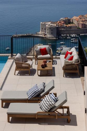a balcony with chairs and a view of the water at Villa Astoria Dubrovnik in Dubrovnik